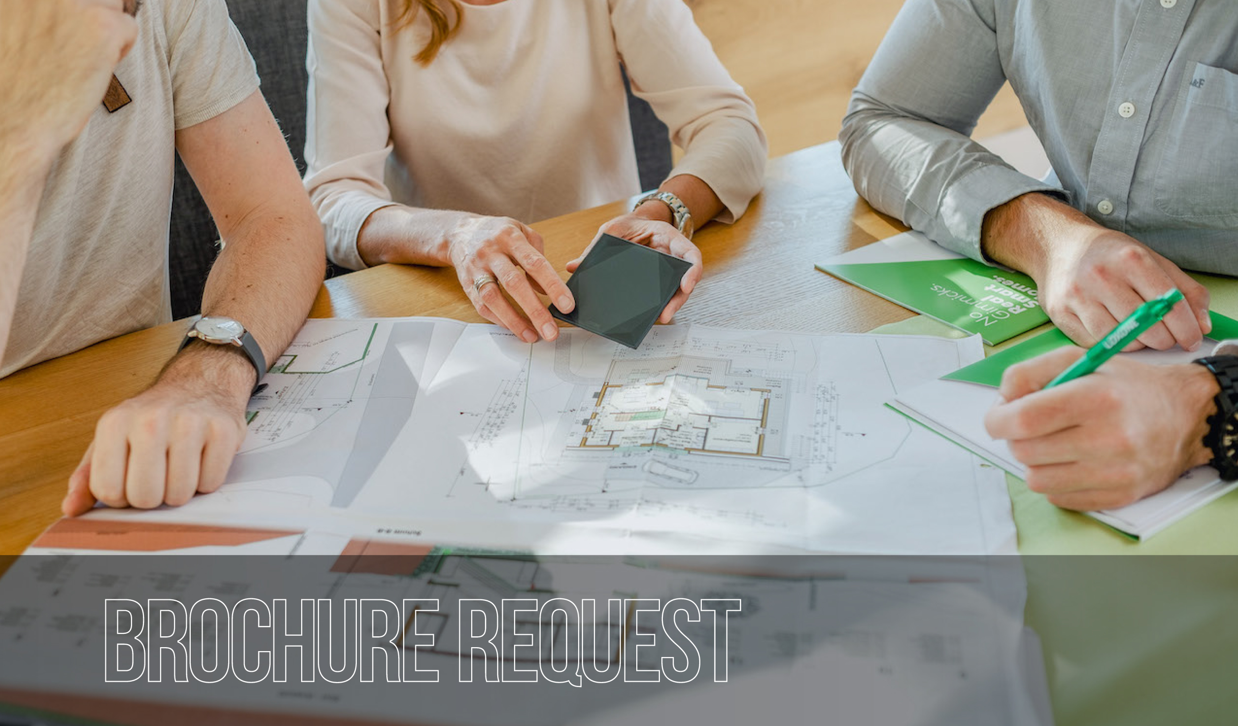 3 people planning smart home on paper - SKM Smart Living