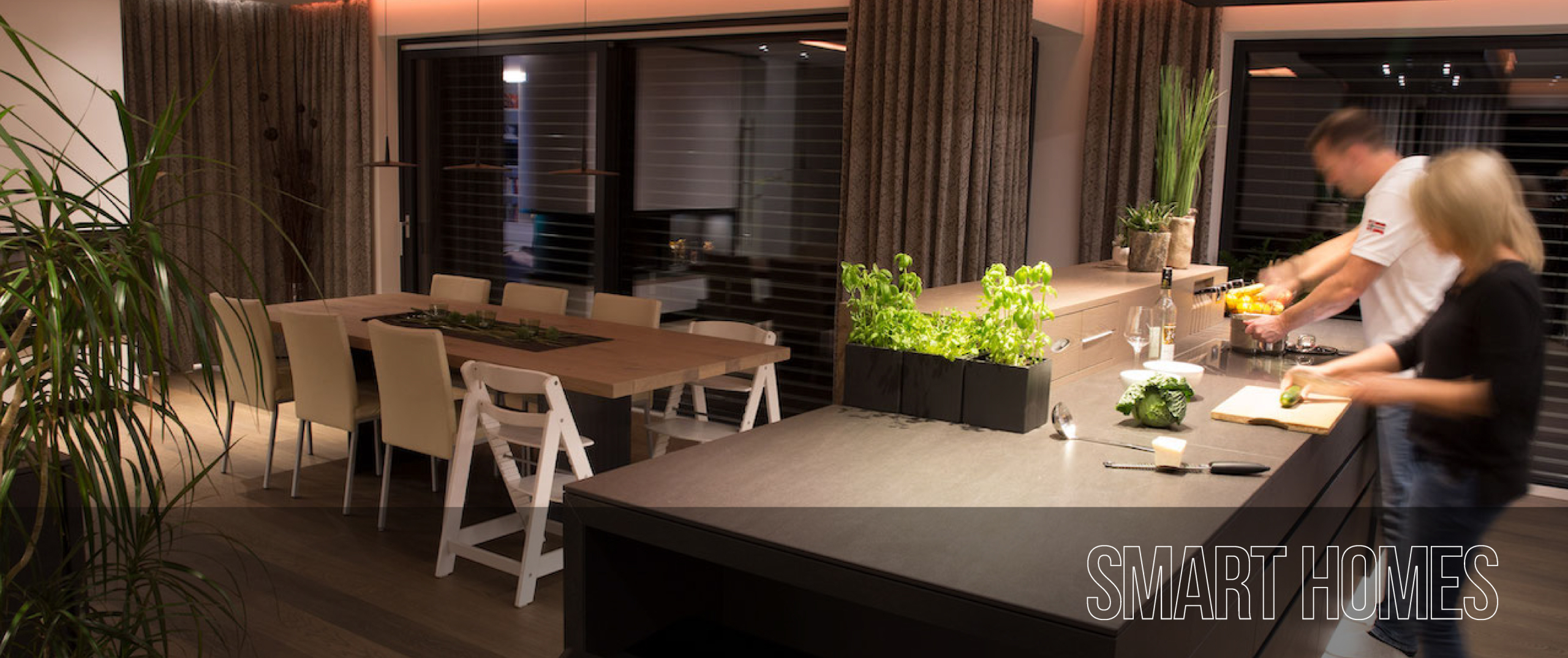 A couple preparing a meal in a stylish Smart Home kitchen diner